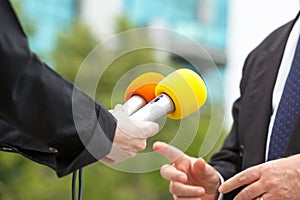 Female reporter conducting media interview with businessman or politician