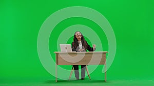 Female reporter at the desk isolated on chroma key green screen background. Full shot african american woman tv news