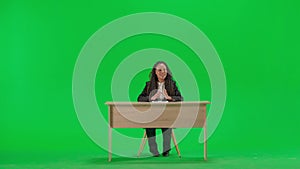 Female reporter at the desk isolated on chroma key green screen background. Full shot african american woman tv news