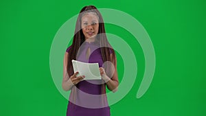 Female reporter isolated on chroma key green screen background. African American woman news host in dress reading from