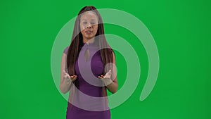 Female reporter isolated on chroma key green screen background. African American woman news host in dress telling the