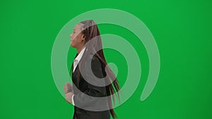 Female reporter isolated on chroma key green screen background. African American woman news host presenter in suit runs