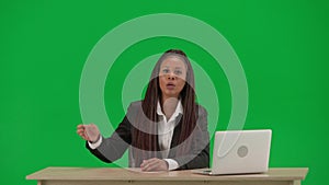 Female reporter isolated on chroma key green screen background. African American woman news host in suit at the desk