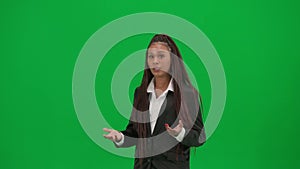 Female reporter isolated on chroma key green screen background. African American woman news host in suit talking