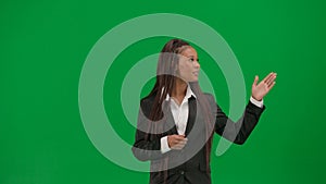 Female reporter isolated on chroma key green screen background. African American woman news host in suit talking showing