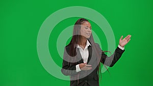 Female reporter isolated on chroma key green screen background. African American woman news host in suit talking showing