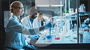 Female Research Scientist Uses Micropipette to Mix Liquids in a Sample Test Tube in a Modern Labor