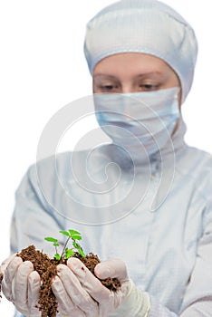 Female researcher biologist holding soil in his hands