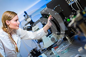 Female researcher carrying out research in a physics/chemistry lab