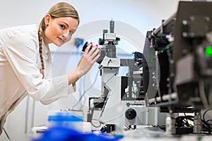 Female researcher carrying out research in a physics/chemistry lab