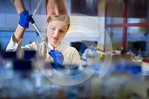 Female researcher carrying out research in a physics/chemistry lab