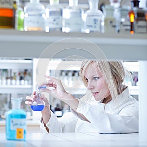 female researcher holding up a test tube