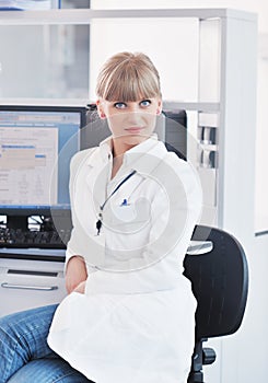 Female researcher holding up a test tube in lab