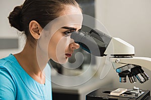 Female researcher with a microscope