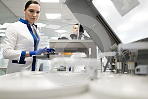 Female researcher using advia immunoassay system in lab
