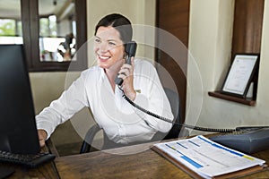 Female resort receptionist working at the front desk