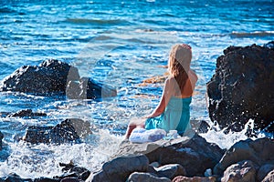 Female resting on stone. Natural landscape. Beach vacation and spa. Time to relax. Relaxation and meditation concept