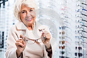 Female retiree in optician store