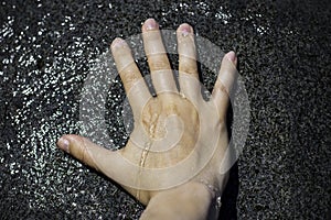 Female right hand on water statue. Refreshes with cold water during hot weather, cooling down in the heat, warm summer