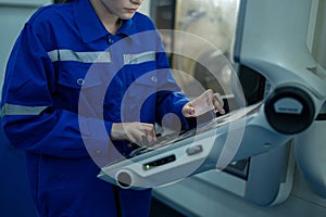 Female Robotics engineers Using Controller to Remotely Operate programming and Manipulating Robot Hand, Industrial Robotics Design