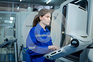 Female Robotics engineers Using Controller to Remotely Operate programming and Manipulating Robot Hand, Industrial Robotics Design