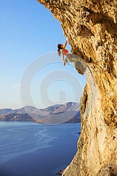 Female rock climber on challenging route