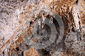 Female rock climber on a cliff face photo