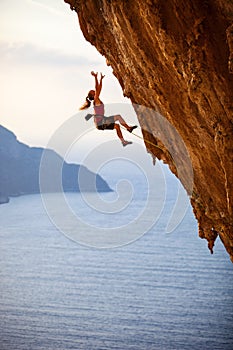 Female rock climber falling of a cliff