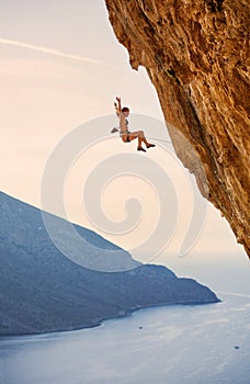 Female rock climber falling of a cliff while lead climbing