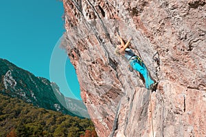 Female Rock Climber on high Wall