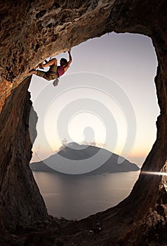 Female rock climber at sunset, Kalymnos, Greece