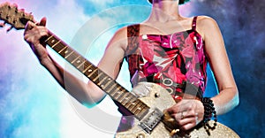 Female rock guitarist on stage in concert