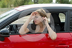 Female rookie new driver young beautiful woman scared and stressed while driving car in fear and shock