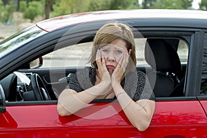 Female rookie new driver young beautiful woman scared and stressed while driving car in fear and shock