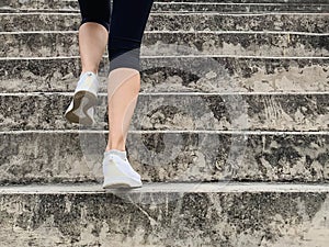 Female runner athlete going up stairs doing cardio sport workout.