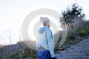 Female runner athlete going up stairs in urban city doing cardio sport workout run outside