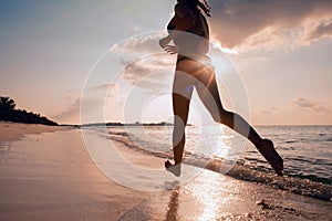 Female Runner on the Beach at Sunset silhouette in air farther