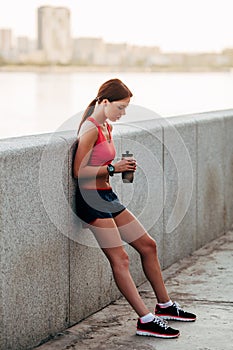 Female runner with bottled water