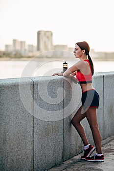 Female runner with bottled water