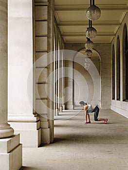 Female Runner Crouching In Portico