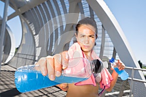 Female runner with energetic drinks for hydration