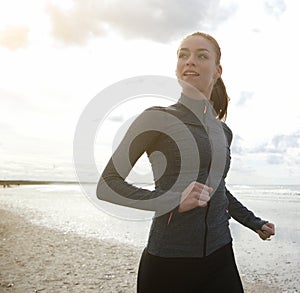 Female runner exercising by the beach