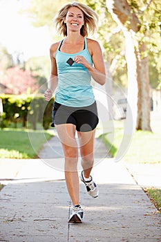 Female Runner Exercising On Suburban Street