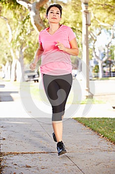 Female Runner Exercising On Suburban Street