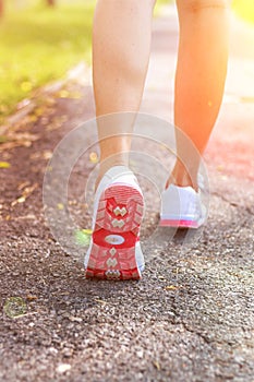 Female runner feet running closeup on shoe