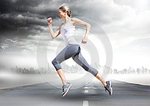 Female runner going across road with skyline and storm