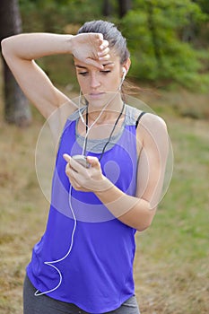 Female runner looking at chronometer