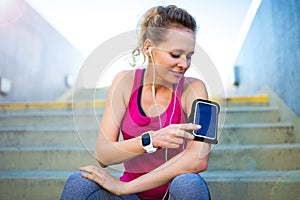 Female Runner With Mobile Phone And Smart Watch