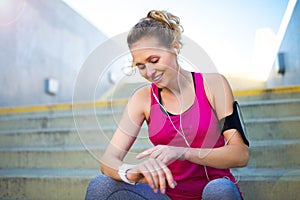 Female Runner With Mobile Phone And Smart Watch