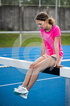 Female runner relaxing before competition